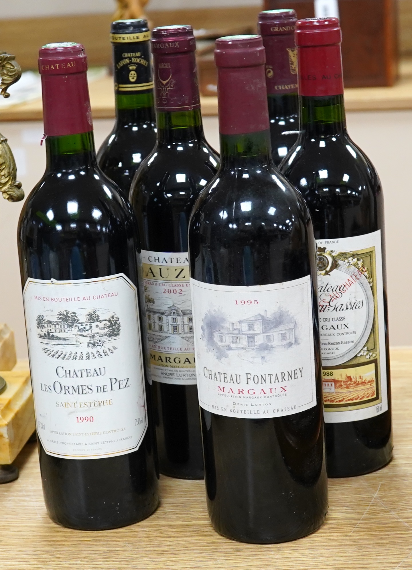 Six mixed bottles of French red wine: a bottle of 1992 grand cru classe de graves, Chateau Olivier, a bottle of 1993 grande classe Chateau Lafon- Rochet, Saint-Estephe, a bottle of 1988 grand cru classe, Dauzac, Margaux,